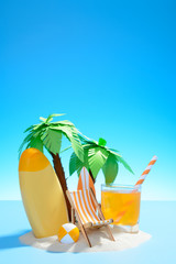 View of the Sunny sandy island with palm trees, sun lounger, surfboard, orange juice, ball and sunscreen