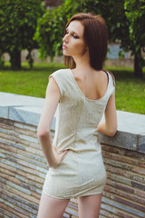 Young beautiful girl with brown-haired woman in dress walking walks in park in nature and posing. Fashion photo