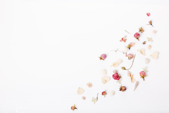 Flowers composition. Frame made of dried rose flowers on white background. Flat lay, top view, copy space
