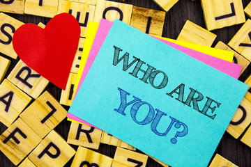 Handwritten text showing Who Are You Question. Conceptual photo Personality Identity Profile, About Me Or You  written on colorful sticky note on the letter background Love Heart for Loving
