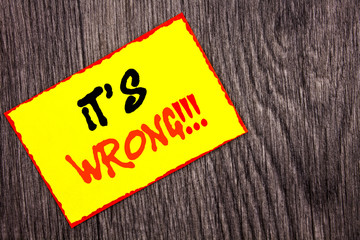 Conceptual hand writing text showing It Is Wrong. Concept meaning Correct Right Decision To Make Or Mistake Advice written on Yellow Sticky Note Paper on the wooden background.