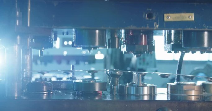 Close up shot of a punch press forming metal parts