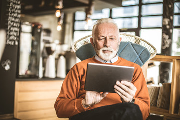 Senior businessman using technology.