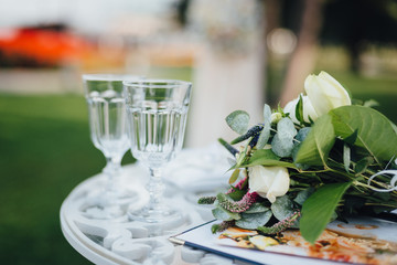 Wedding bouquet with glasses on the ceremony table