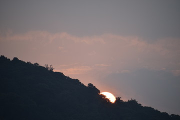 Sunset under mountain