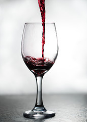 Red wine pouring into a wine glass