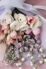 Beautiful spring bouquet with tender ranunculus flowers and tulips, elegant floral decoration