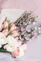 Beautiful spring bouquet with tender ranunculus flowers and tulips, elegant floral decoration