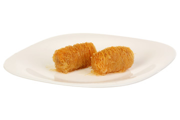Traditional oriental dessert baklava with syrup. Two pieces of baklava on plate, isolated.