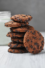 oatmeal cookies with chocolate and milk on a white background