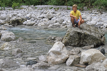 boy at river Iupshara in Abkhazia