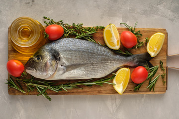 Fresh Raw Dorado with lemon, thyme, cherry and rosemary .