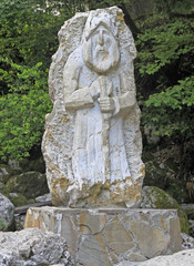 Fototapeta premium statue of old man on road to lake Ritsa