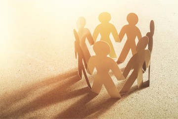 Circle of paper people on paper background