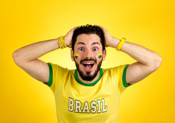 Brazilian supporter of National Team of football is surprised.