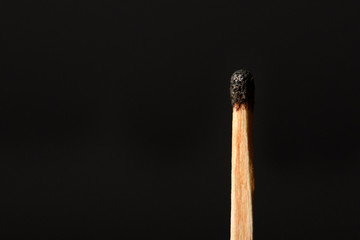 Match with the burned head on a black background closeup