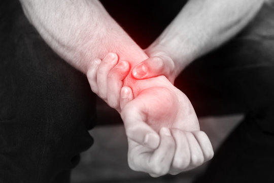 Man Holding Sore Wrist In His Hand