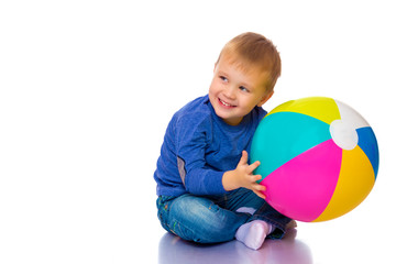 Fototapeta na wymiar A little boy is playing with a ball.