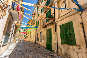 Old street of Palma de Mallorca with green doors and shutters © Dmitrii