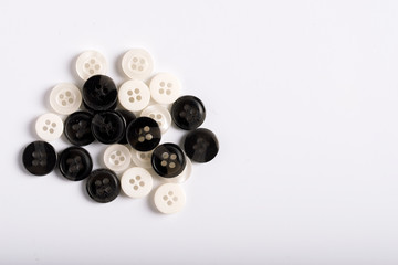 Buttons for clothes on a white background, top view.