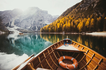 Old rowing boat on a lake in the Dolomites in fall