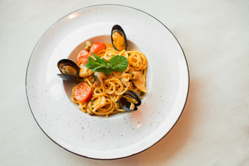 Spaghetti with mussels seafood. Soba noodles with shrimps and vegetables. Asian food. Pasta with seafood in tomato sauce.