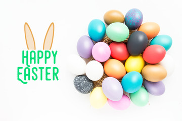 Multi-colored Easter eggs in nest on wooden background, selective focus image. Happy Easter card 