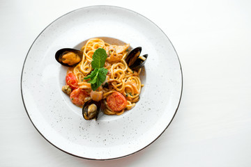 Spaghetti with mussels seafood. Soba noodles with shrimps and vegetables. Asian food. Pasta with seafood in tomato sauce.