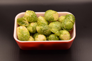 Seasoned Brussel sprouts on a black background. 