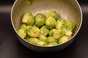 Seasoned Brussel sprouts on a black background. 