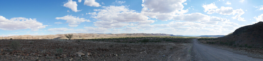4x4 road crossing the colorful desert at Twyfelfontein, in the majestic Damaraland Brandberg, scenic travel destination in Namibia, Africa.