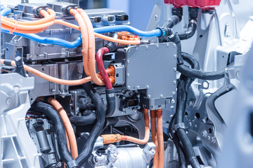 Chassis of the electric car with powertrain and power connections closeup. Blue toned.