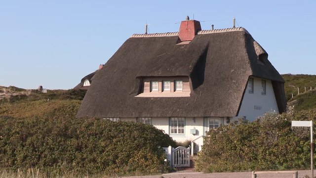 Traditional north German house with thatched rooves near town of H&ouml;rnum, Sylt, Germany.