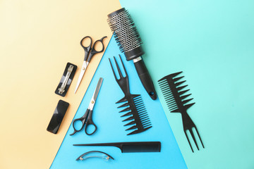 Flat lay composition with professional hairdresser tools on color background
