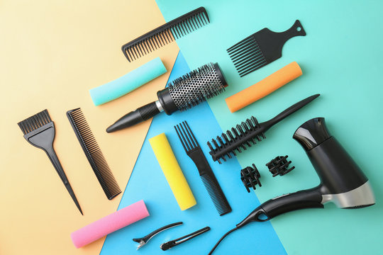 Flat lay composition with professional hairdresser tools on color background