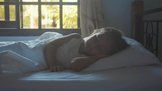 Portrait of little cute girl sleeping in the bed at morning