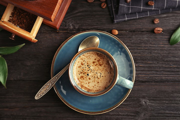 Flat lay composition with cup of aromatic hot coffee on wooden table