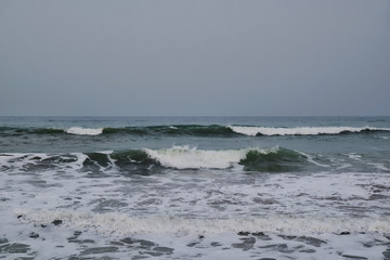 Landscape with stormy sea in cloudy weather