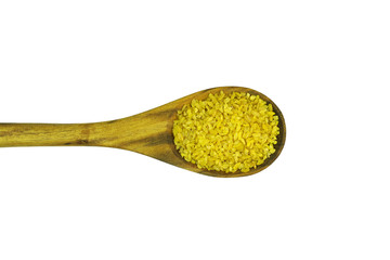 Turkish bulgur in wooden spoon isolated on white background. 
