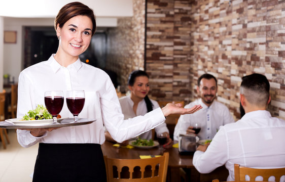 Female waiter showing country restaurant