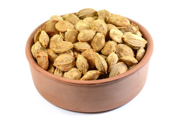 Dry apricot nut in a ceramic bowl on white background.