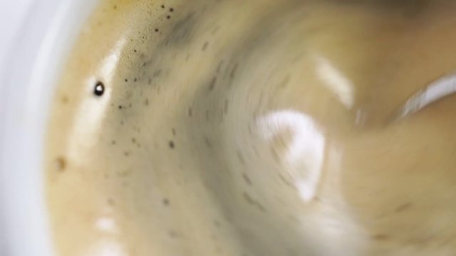 Mixing shugar in cup with americano