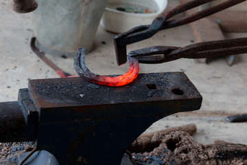 Farrier making horseshoe 
