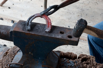 Farrier making horseshoe 
