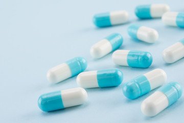capsules of medicine on blue background