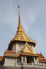 Fototapeta premium Ornate roof tops decorated with gold of the Wat Trimit temple in Chinatown, Bangkok, Thailand.