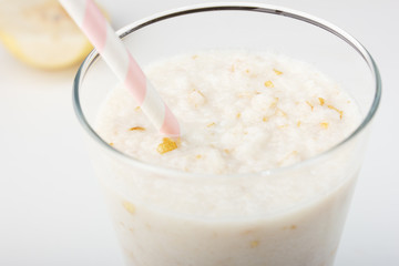 Healthy eating,diet smoothie drink is made from natural  pear and banana with a straw on a white wooden background