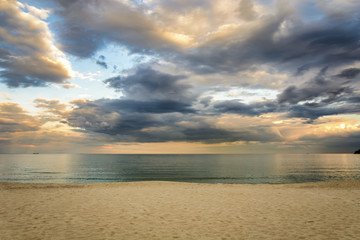 Naklejka na ściany i meble Beach at sunset, Dramatic clouds over the sea.
