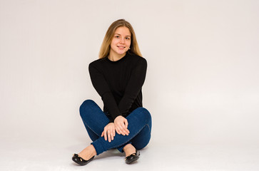 beautiful girl in different poses shows different emotions on different backgrounds in different clothes