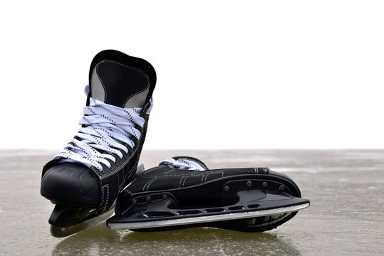 Black hockey skates on a ice rink with copy space.